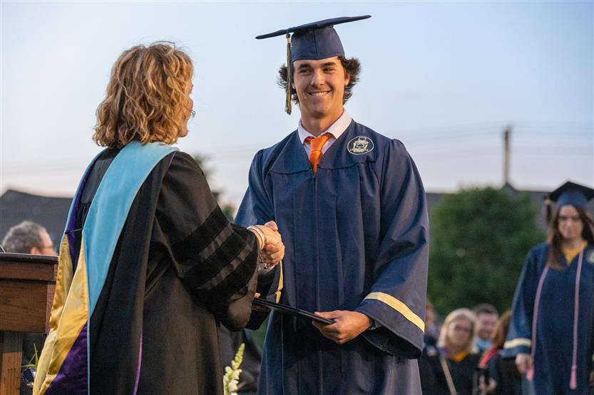 Students wearing blue graduation robes